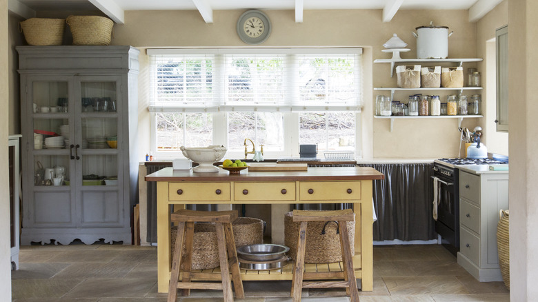 Retro kitchen with a pastel yellow work station in the center
