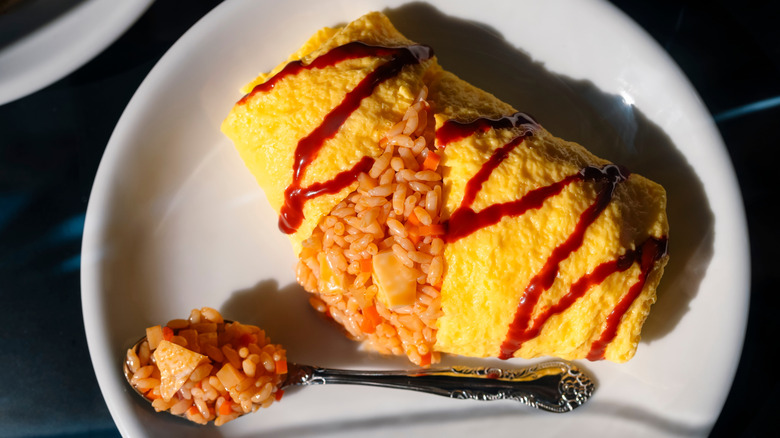 Omurice Japanese fried rice omelet on plate with spoon