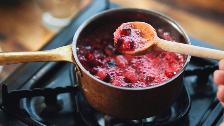 Cranberry sauce cooking on a stovetop pan
