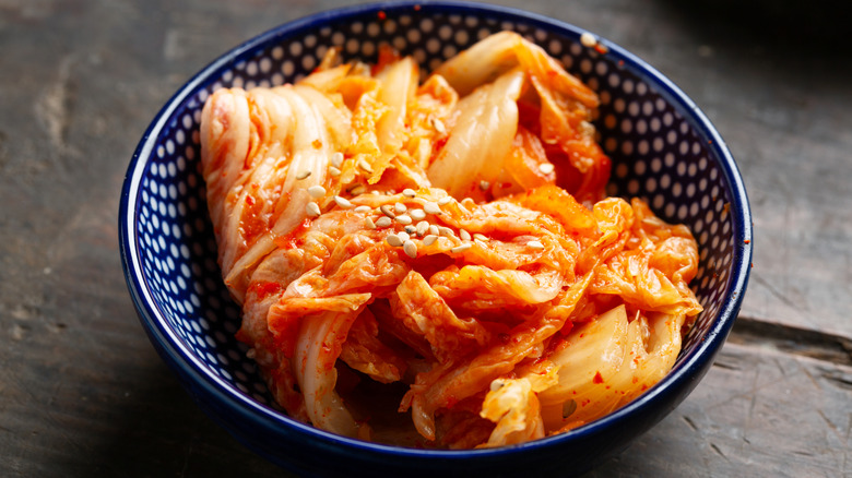Bowl of kimchi garnished with sesame seeds