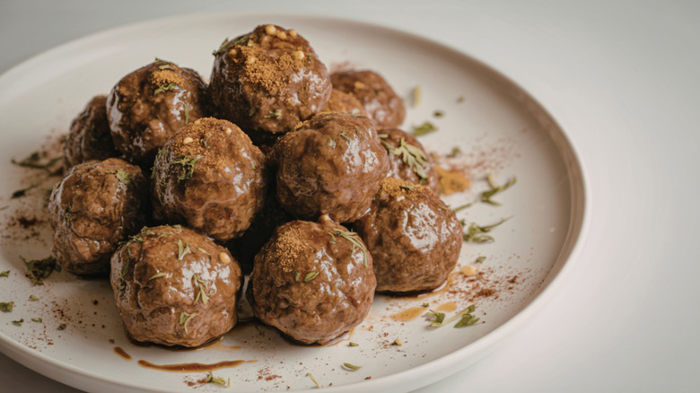 Glazed beef meatballs on white plate