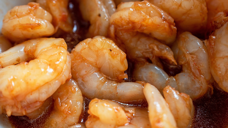 Raw shrimp in red marinade sauce