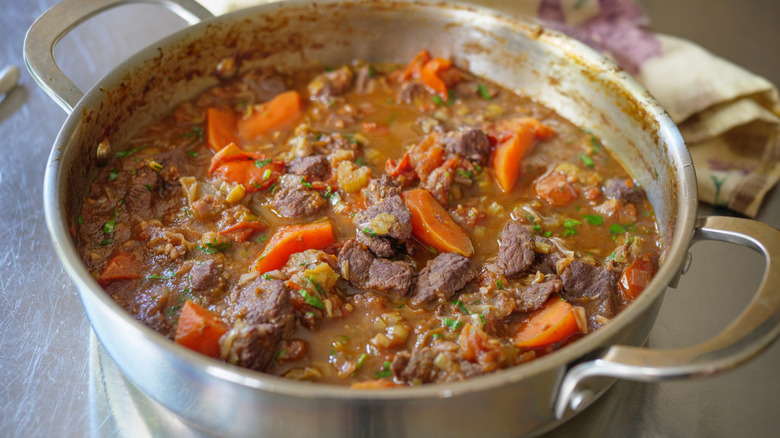 A metal pan of beef and carrot stew