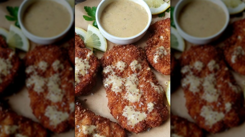 Crispy pretzel-coated chicken breasts drizzled with honey mustard sauce