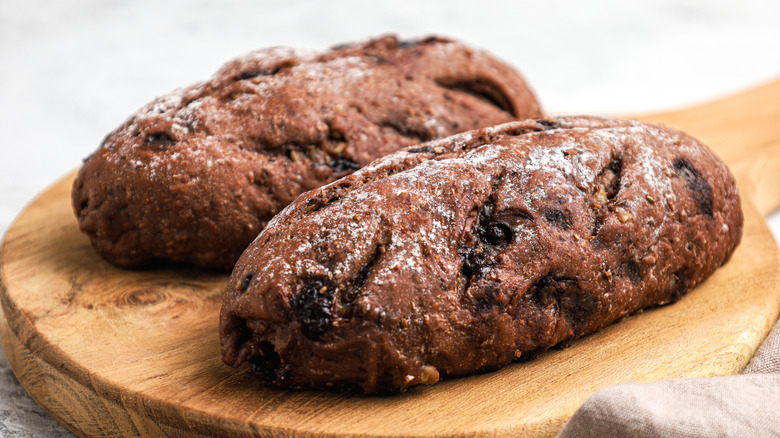 Two chocolate sourdough loaves on wooden board