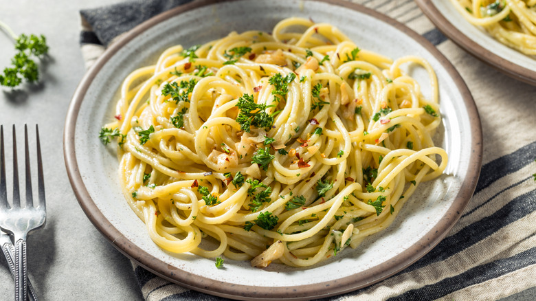 Plate of spaghetti with garlic, chili flakes, and herbs