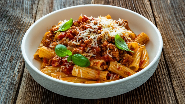 A bowl of rigatoni bolognese pasta
