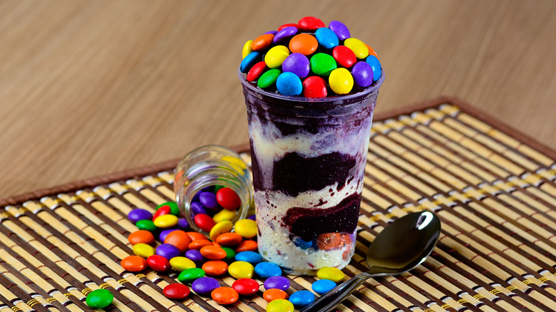 M&M ice cream being scooped out of cup