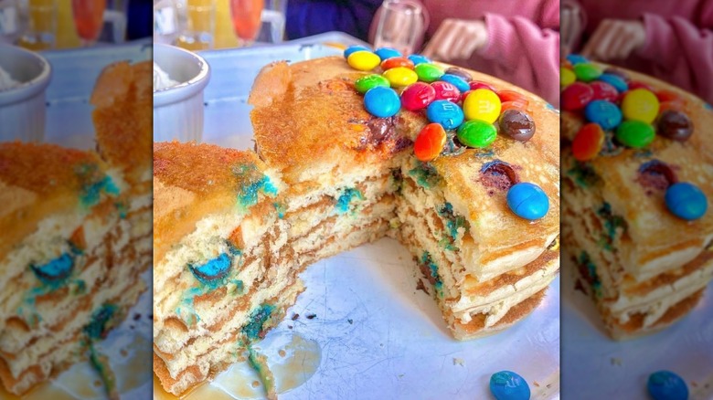 M&M pancake in skillet with spatula