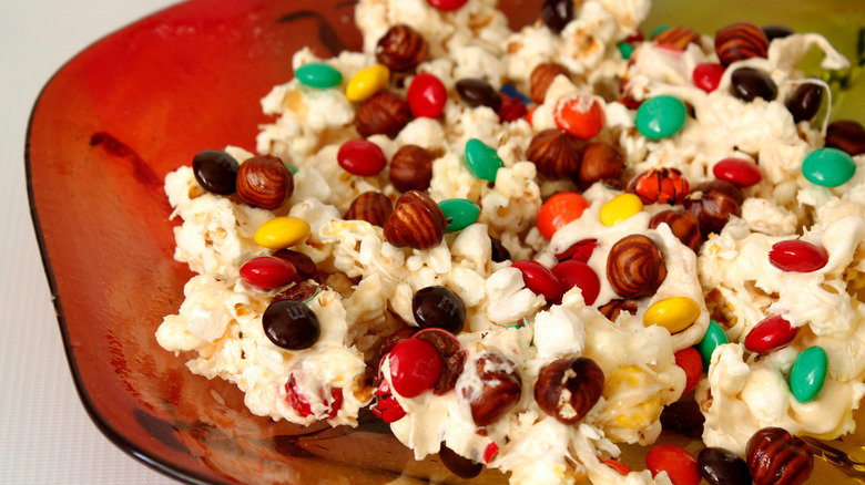 Bowl of popcorn mix with hazelnuts and M&Ms