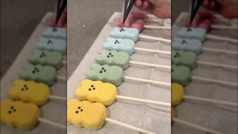 Easter Peeps cake pops lined up on sheet of parchment paper