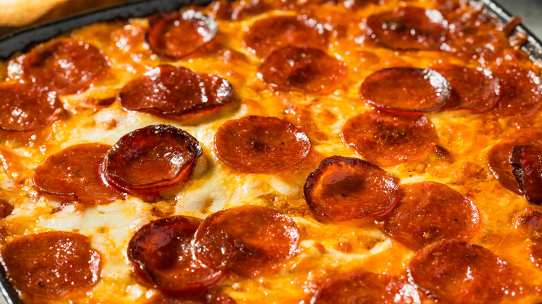 Close up of cheesy pepperoni dip in skillet
