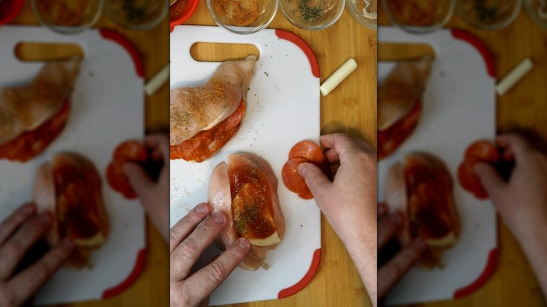 Stuffing chicken breasts with pepperoni, cheese, and pizza sauce