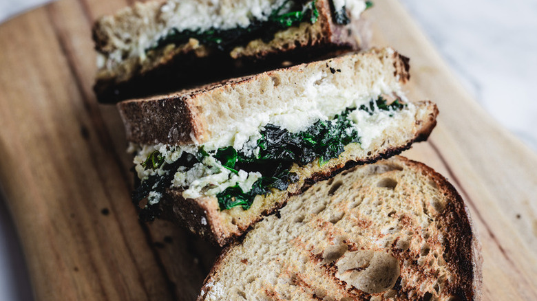 Ricotta and spinach grilled cheese sandwiches on wooden board