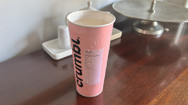 Pink Crumbl cookie cup full of dirty soda