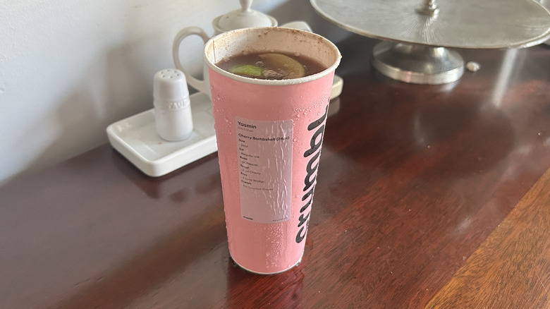 Pink Crumbl cookie cup full of dirty soda