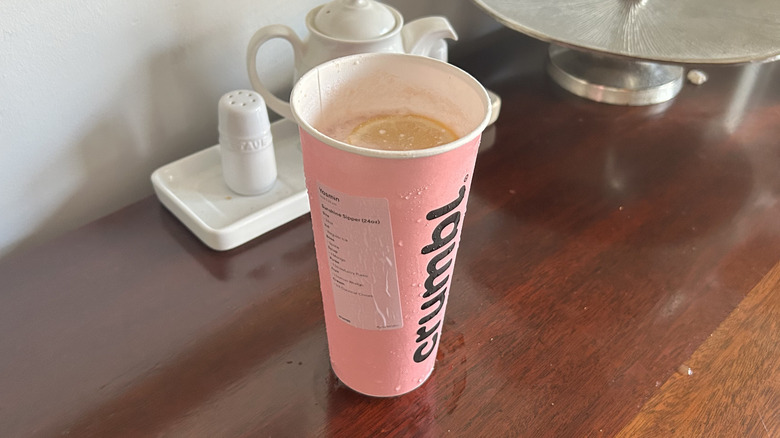 Pink Crumbl cookie cup full of dirty soda