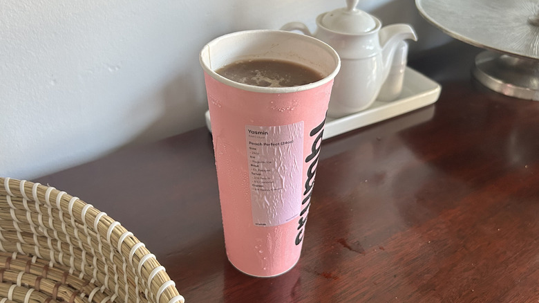 Pink Crumbl cookie cup full of dirty soda
