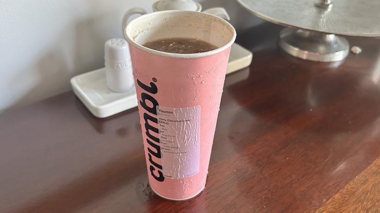Pink Crumbl cookie cup full of dirty soda