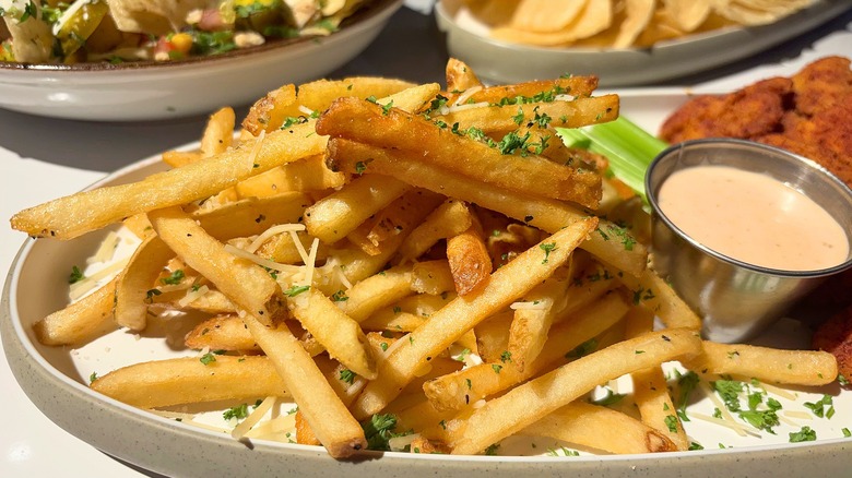 Dave & Buster's Fries GPT and sauce on white plate on white table