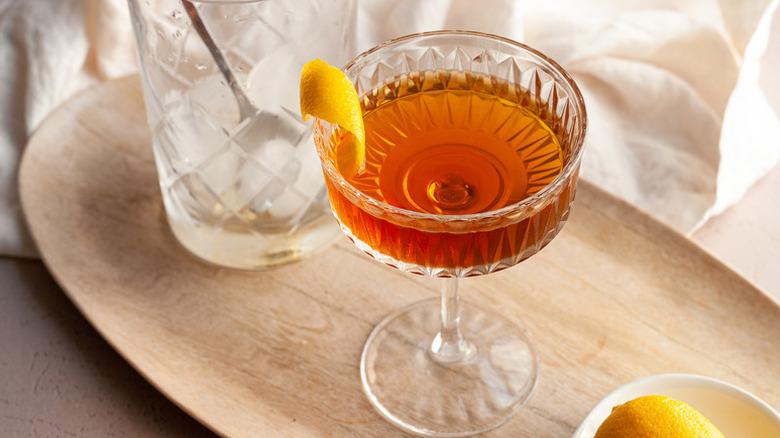 Whiskey cocktail in glass with lemon peel garnish