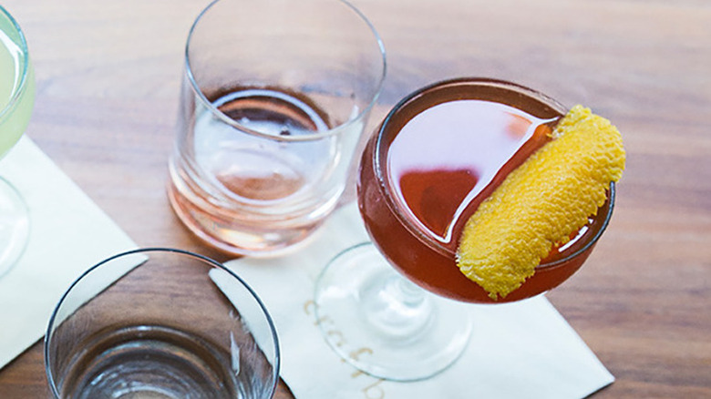 Negroni cocktail in glass with slice of orange peel resting on top
