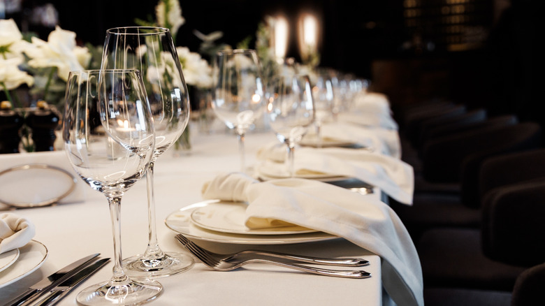 Several plates, glasses and cutlery laid out at a fine dining restaurant
