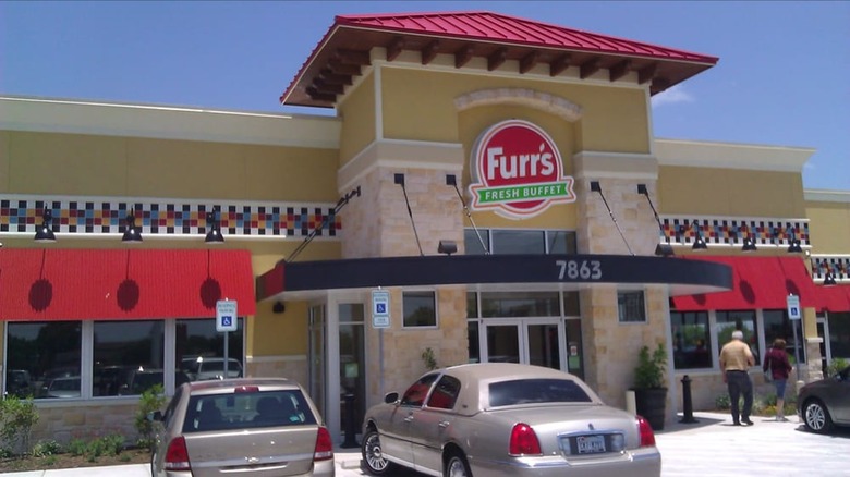 Outside Furr's Fresh Buffet with sign on building, people going inside, and cars out front