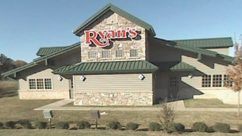 Outside Ryan's building with sign on building
