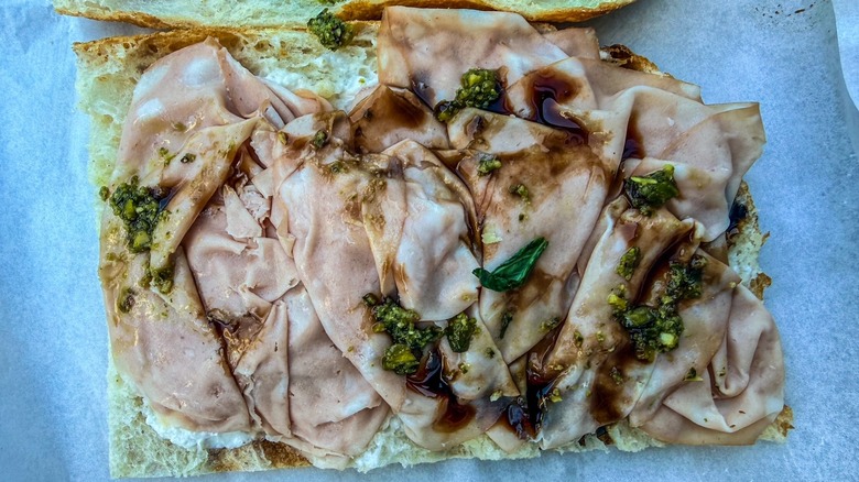 slices of mortadella on Italian focaccia with pesto