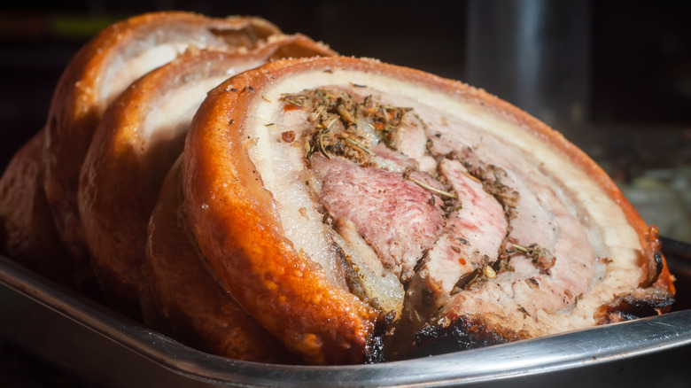 sliced porchetta on a metal platter