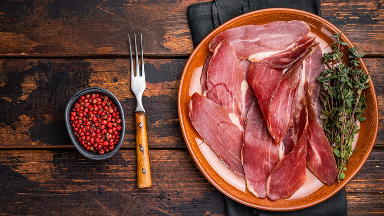 sliced speck on a plate