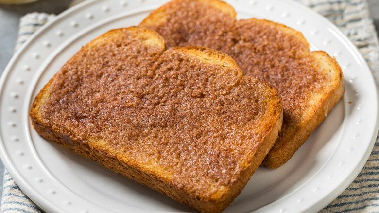 Two slices of cinnamon sugar toast on white plate