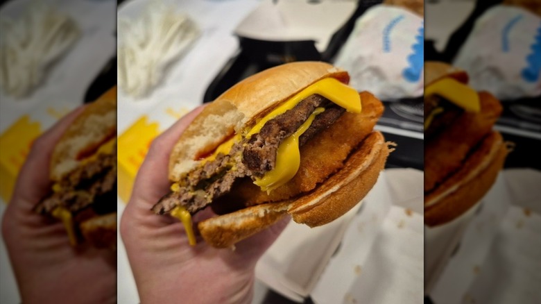 Hand holding McDonald's Surf and Turf burger