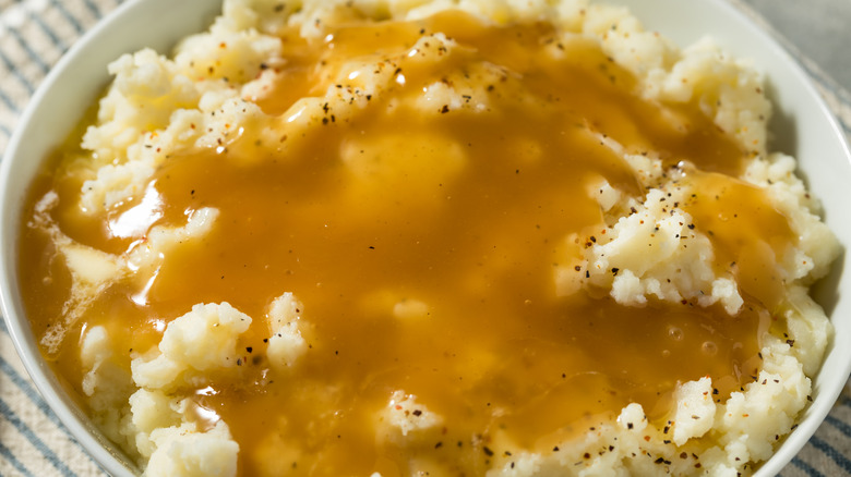 Bowl of mashed potatoes topped with gravy