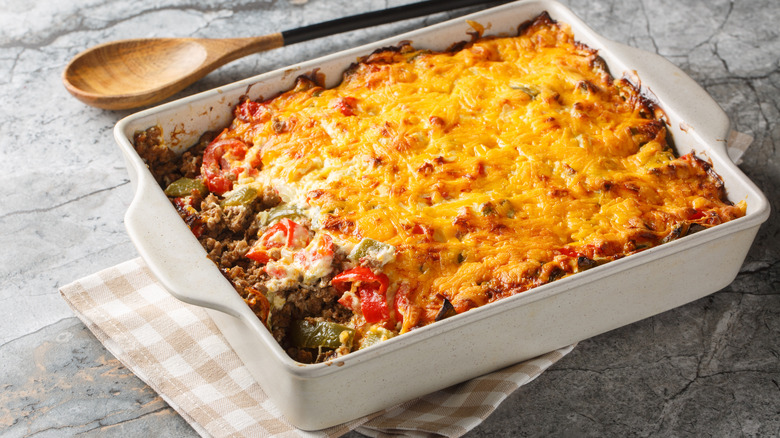 Cheesy beef casserole in white baking dish