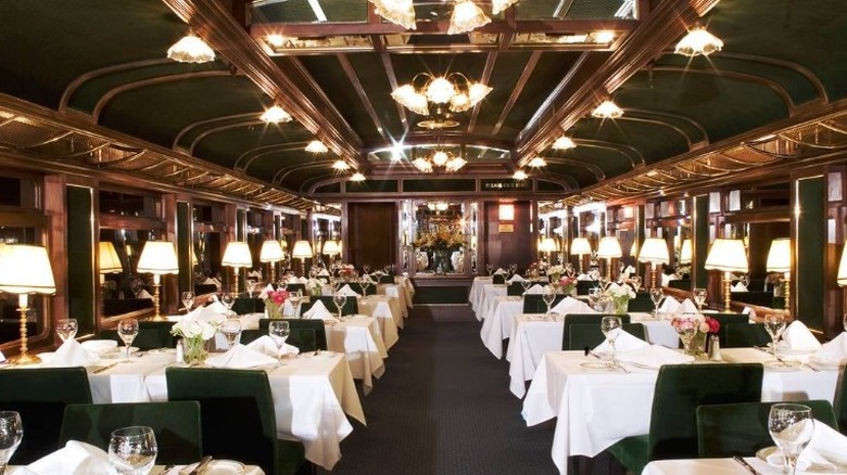 Inside of a restaurant with white table clothes