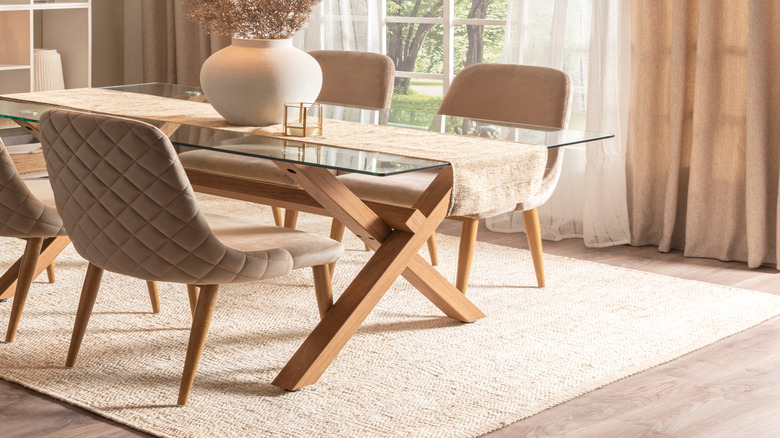 Spacious dining room with sheer and beige curtains