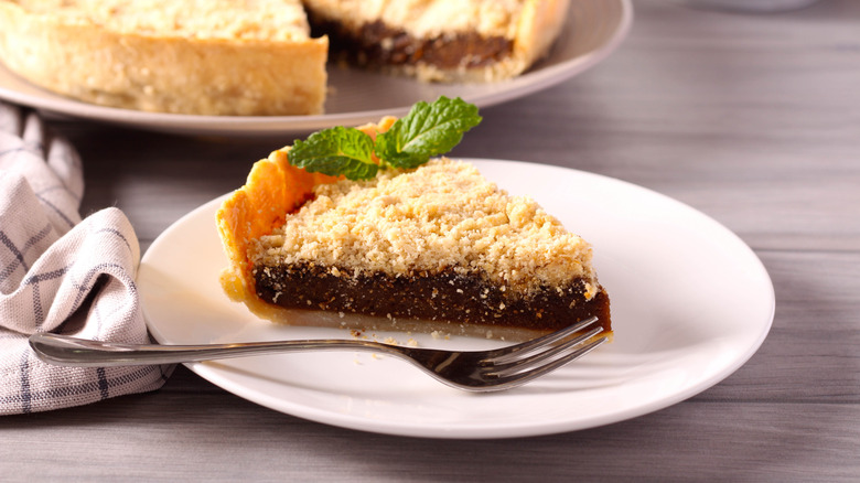 Slice of shoofly pie on plate with fork