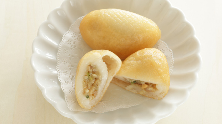A pillow-shaped dumpling on a white plate