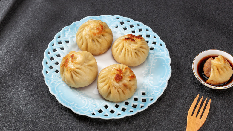 A golden dumpling on a blue plate