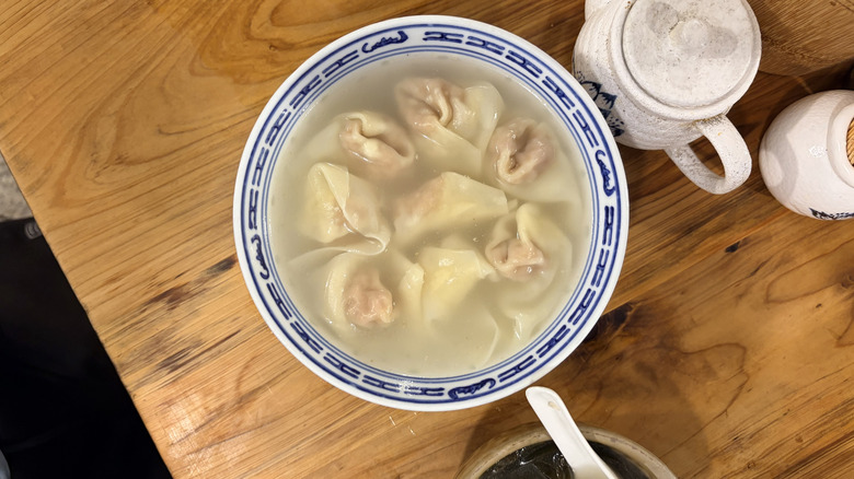 Dumplings floating in a bowl of broth
