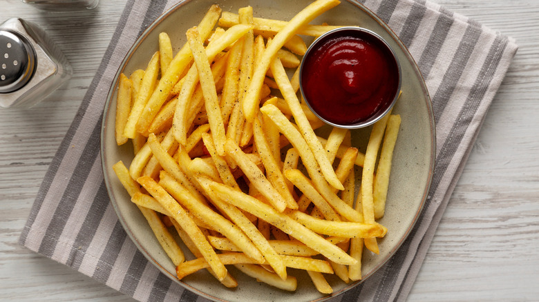 Plate of French fries with ketchup