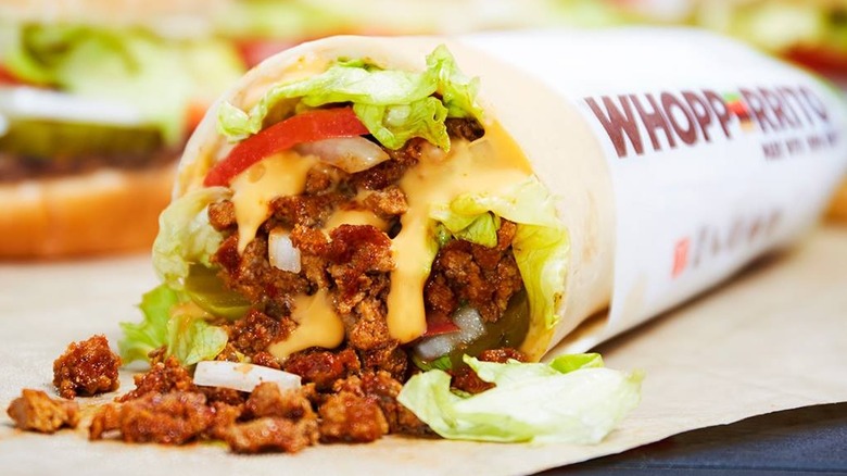 A Whopperito with beef, lettuce, tomato and cheese in a tortilla