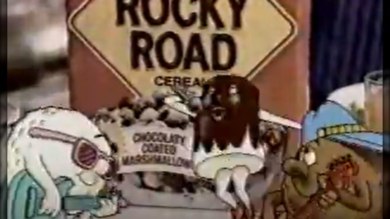 Cartoon characters signing and playing guitars in front of a Rocky Road Cereal box in an '80s-era TV ad
