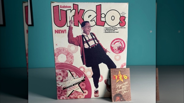 Urkel-Os cereal box and flip book prize in front of a teal wall