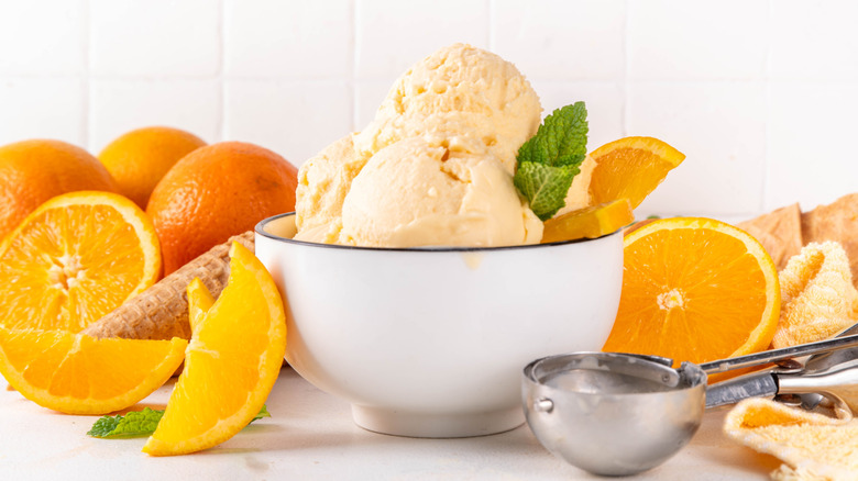 Homemade orange creamsicle ice cream next to ingredients