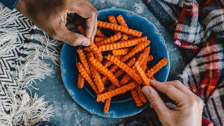 Aerial shot of two people eating sweet potato fries from Culver's