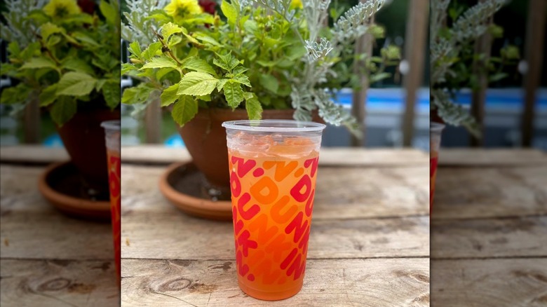 Dunkin' Peach Passionfruit Refresher on outdoor table