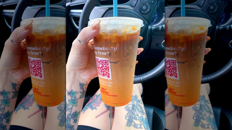 Hand holding Peanut Butter Cup Macchiato in car